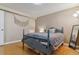 Cozy bedroom features a wood floor, soft lighting, and a decorative macrame hanging at 12520 W Virginia Ave, Lakewood, CO 80228