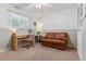 Cozy bedroom with a light green color scheme and a comfortable seating area at 12520 W Virginia Ave, Lakewood, CO 80228