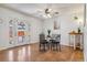 Bright dining area with access to the outdoors, hardwood floors, and stylish furnishings at 12520 W Virginia Ave, Lakewood, CO 80228