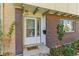 Inviting front entry with a brick facade, decorative plants, and a welcoming 