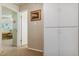 Neutral hallway featuring built-in storage and a view into a bright, carpeted room at 12520 W Virginia Ave, Lakewood, CO 80228