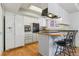 Well-lit kitchen featuring modern appliances, white cabinets, and a functional layout for easy meal preparation at 12520 W Virginia Ave, Lakewood, CO 80228