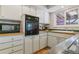 Functional kitchen with updated appliances, abundant cabinet space, and a bright window above the sink at 12520 W Virginia Ave, Lakewood, CO 80228