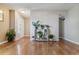 Bright foyer featuring hardwood floors, neutral walls, and stylish decor; with ample natural light at 12520 W Virginia Ave, Lakewood, CO 80228