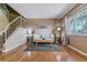 Cozy living room with hardwood floors, a comfortable sofa, and a staircase leading to the upper level at 12520 W Virginia Ave, Lakewood, CO 80228