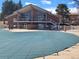 View of community clubhouse and fenced pool with safety cover at 12520 W Virginia Ave, Lakewood, CO 80228