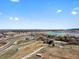 Beautiful aerial view of a community near a highway, pond, lake, and farmland under a bright sky at 14422 Pansy Loop, Morrison, CO 80465