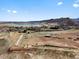Scenic aerial view of ranchland featuring a pond, mountain views, and a rural setting at 14422 Pansy Loop, Morrison, CO 80465