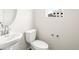 Bathroom features a contemporary sink, mirror and toilet complemented by neutral walls and flooring at 14422 Pansy Loop, Morrison, CO 80465