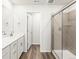 Modern bathroom boasting a sleek glass-enclosed shower and white vanity with stylish fixtures and flooring at 14422 Pansy Loop, Morrison, CO 80465