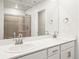 Bathroom featuring double sinks with modern fixtures, a white countertop, and a large mirror at 14422 Pansy Loop, Morrison, CO 80465
