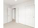 Bedroom featuring neutral carpet, an open doorway and closet with sliding doors at 14422 Pansy Loop, Morrison, CO 80465