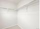 Walk-in closet featuring white walls, carpet flooring, and custom shelving for ample storage at 14422 Pansy Loop, Morrison, CO 80465