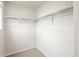 Walk-in closet featuring white walls, carpet flooring, and custom shelving for ample storage at 14422 Pansy Loop, Morrison, CO 80465