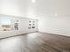 Expansive living room with sleek wood floors and abundant natural light at 14422 Pansy Loop, Morrison, CO 80465