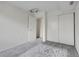 Bedroom with carpet, closet, and a white door to the hallway at 1094 S Dearborn St # 301, Aurora, CO 80012