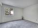 Bright bedroom with neutral carpet, a large window, and minimalist decor at 1094 S Dearborn St # 301, Aurora, CO 80012