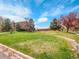 Well-maintained community grounds showcasing lush green grass and mature trees under a partly cloudy sky at 1094 S Dearborn St # 301, Aurora, CO 80012
