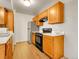 Functional kitchen features classic wood cabinets, white countertops, and essential appliances at 1094 S Dearborn St # 301, Aurora, CO 80012