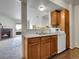 Kitchen with double sink and view of a comfortable living room with fireplace and balcony at 1094 S Dearborn St # 301, Aurora, CO 80012