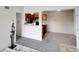 Living room with carpet and a glimpse of the kitchen appliances at 1094 S Dearborn St # 301, Aurora, CO 80012