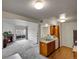Open living room with fireplace, balcony access, and view into the kitchen at 1094 S Dearborn St # 301, Aurora, CO 80012