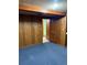 Basement featuring wood paneling, carpeting, and multiple entryways at 2060 S Washington St, Denver, CO 80210