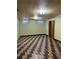 Finished basement with patterned floor, windows, and lighting at 2060 S Washington St, Denver, CO 80210