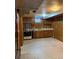 Basement kitchenette featuring classic appliances, wood cabinets, and a compact design at 2060 S Washington St, Denver, CO 80210