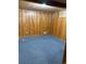 Cozy carpeted basement featuring wood paneling and a window for natural light at 2060 S Washington St, Denver, CO 80210