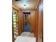 Hallway with wood paneling, tiled floor, and access to various rooms in the basement at 2060 S Washington St, Denver, CO 80210