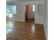 Living room featuring hardwood floors, a window, and a decorative tiled hallway entrance at 2060 S Washington St, Denver, CO 80210