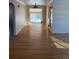 Open-concept living room showcasing hardwood floors and leading to an adjacent room at 2060 S Washington St, Denver, CO 80210