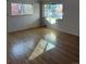 Sunlit living room features hardwood floors and large windows that bring natural light into the home at 2060 S Washington St, Denver, CO 80210