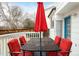 Backyard deck with patio furniture and red umbrella at 9506 Castle Ridge Cir, Highlands Ranch, CO 80129