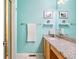 Bathroom with light teal walls, granite countertop, and updated vanity at 9506 Castle Ridge Cir, Highlands Ranch, CO 80129