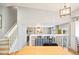 View of living room from kitchen area with white railing at 9506 Castle Ridge Cir, Highlands Ranch, CO 80129