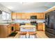 Galley style kitchen with wood cabinets, granite counters, and stainless steel appliances at 9506 Castle Ridge Cir, Highlands Ranch, CO 80129