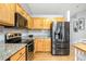 Kitchen with wood cabinets, granite counters, and stainless steel appliances at 9506 Castle Ridge Cir, Highlands Ranch, CO 80129