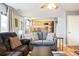 Bright living room features a comfortable couch and a view into the kitchen at 9506 Castle Ridge Cir, Highlands Ranch, CO 80129