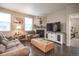 Cozy living room with a fireplace, comfortable seating, a large TV, and natural light from the windows at 7108 Morrison Dr, Frederick, CO 80530