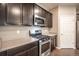 Beautiful kitchen with stainless steel appliances, a gas range, dark cabinetry, and plenty of counter space at 7108 Morrison Dr, Frederick, CO 80530