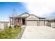 Charming home with a three-car garage, stone accents, and a well-maintained front yard at 7108 Morrison Dr, Frederick, CO 80530
