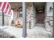 Inviting front porch with stone accents and Adirondack chairs, perfect for relaxing at 7108 Morrison Dr, Frederick, CO 80530