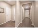 Inviting hallway with hardwood floors and multiple entryways, offering a seamless flow at 7108 Morrison Dr, Frederick, CO 80530