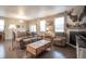 Comfortable living room with a fireplace, sofa, and natural light from windows at 7108 Morrison Dr, Frederick, CO 80530