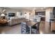 Open-concept living room with hardwood floors connecting to the kitchen at 7108 Morrison Dr, Frederick, CO 80530