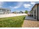 A large backyard with a well manicured lawn, gravel landscaping, and a privacy fence at 7108 Morrison Dr, Frederick, CO 80530