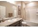 Bathroom with a single sink vanity, large mirror, and a shower over tub at 7108 Morrison Dr, Frederick, CO 80530