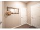 Neutral entryway featuring a coat rack, grey trim, and two white doors at 7108 Morrison Dr, Frederick, CO 80530